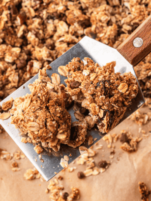 Copycat KIND granola clusters piled in a glass jar with big golden chunks