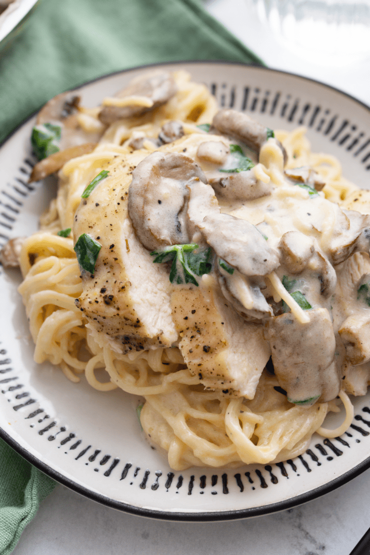 Roasted chicken tossed with homemade garlic herb seasoning on a dinner plate.