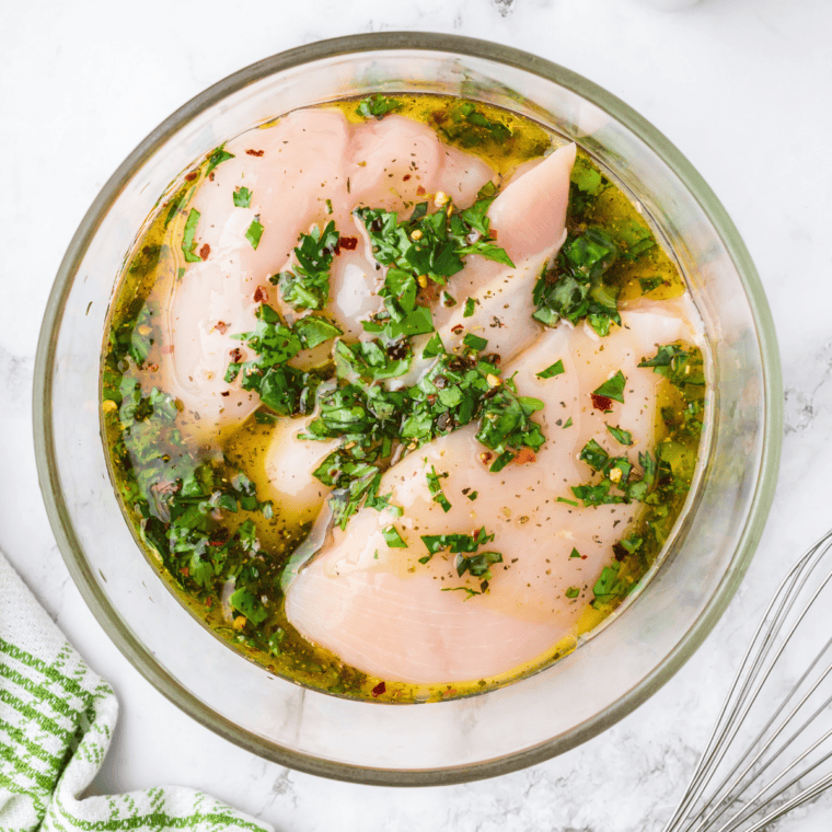 Raw chicken marinating in copycat Lawry's lemon pepper marinade in a zip-top bag