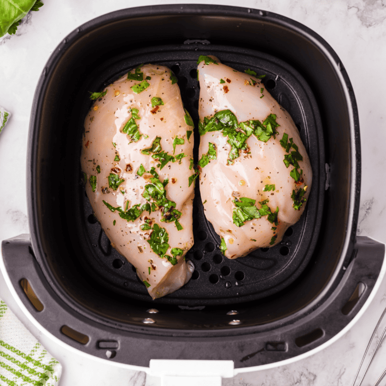 Lemon pepper marinated chicken grilling and being basted with fresh marinade