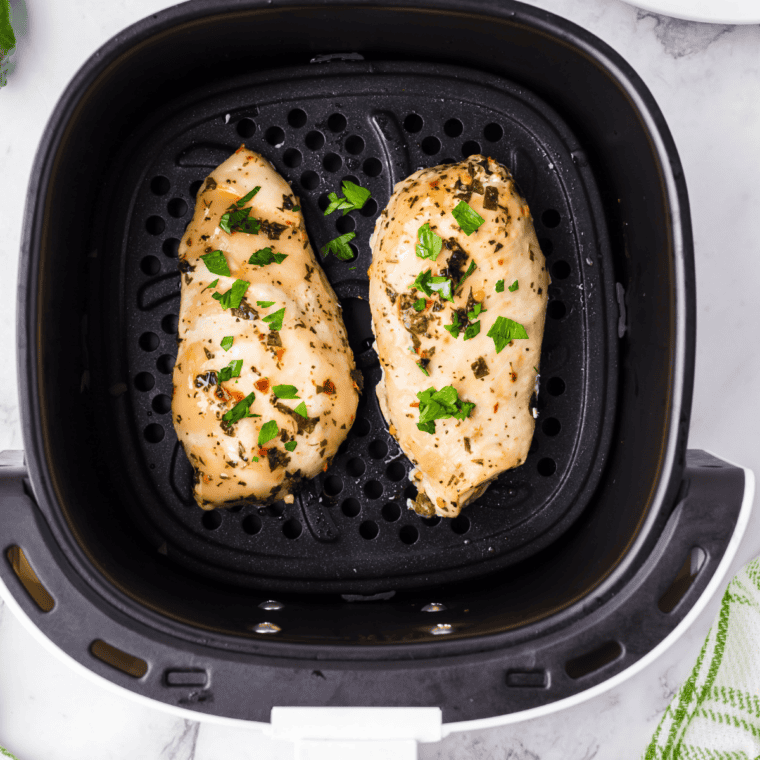 Cooked chicken made with copycat Lawry's lemon pepper marinade, garnished with fresh lemon
