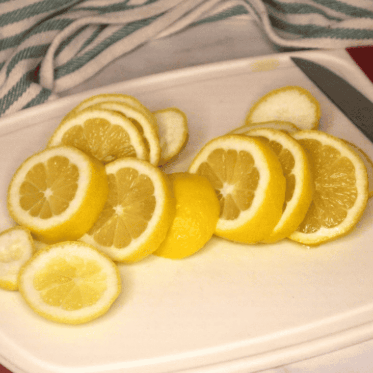 Fresh lemon zest spread on a parchment-lined baking sheet to dry for homemade lemon pepper seasoning