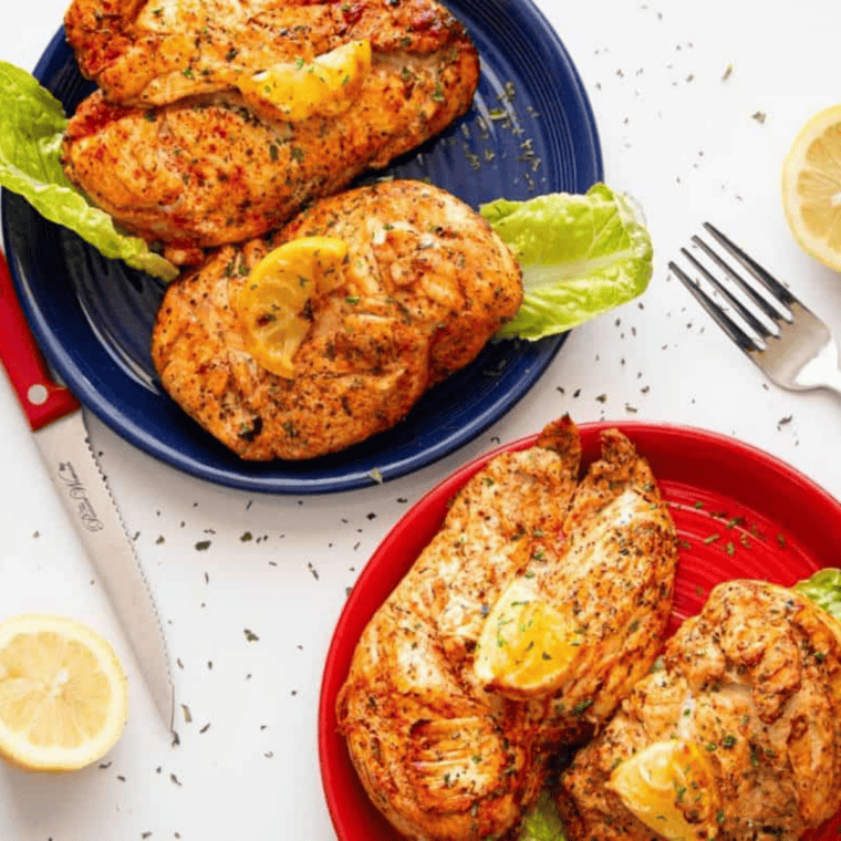 Copycat McCormick lemon pepper seasoning on grilled chicken breasts garnished with fresh lemon slices