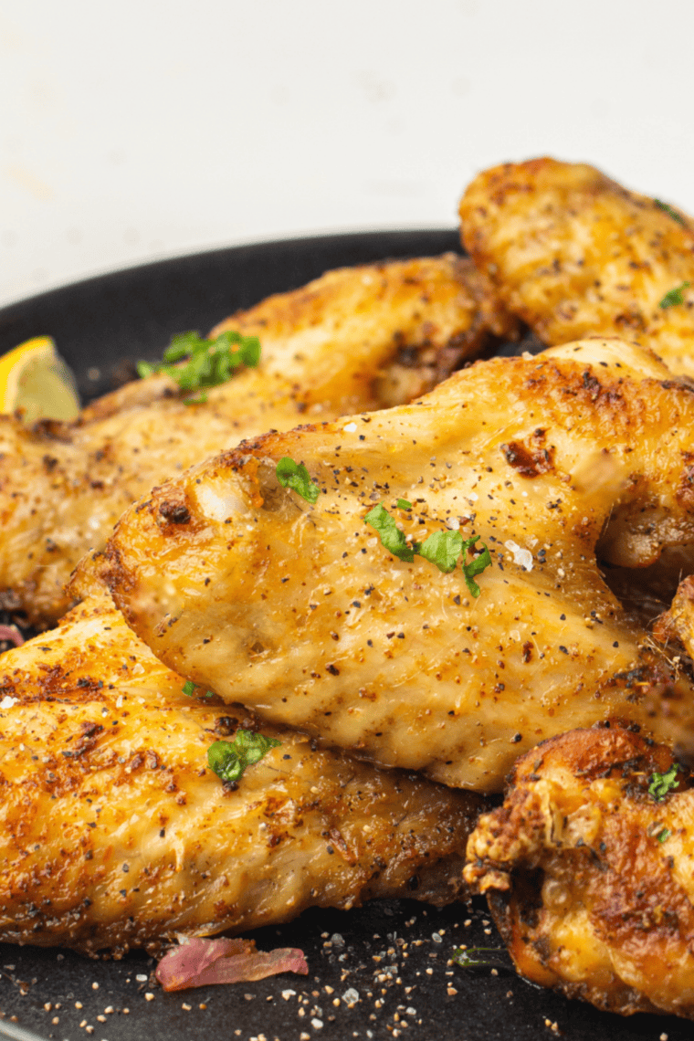 Roasted turkey legs rubbed with copycat Mrs. Dash seasoning on a wooden board