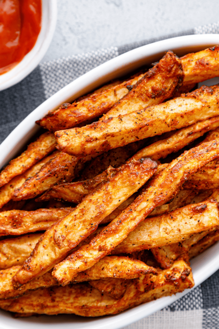 Crispy fries seasoned with homemade salt-free spice blend and a side of dip