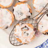 copycat panera blueberry scones with vanilla icing drizzle on cooling rack