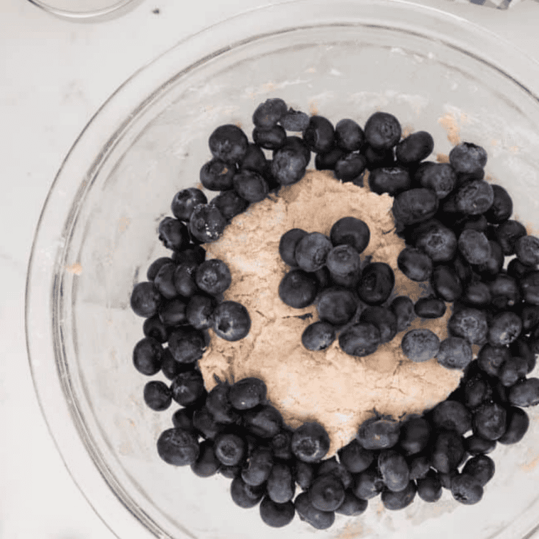 gently folding fresh blueberries into copycat panera scone dough