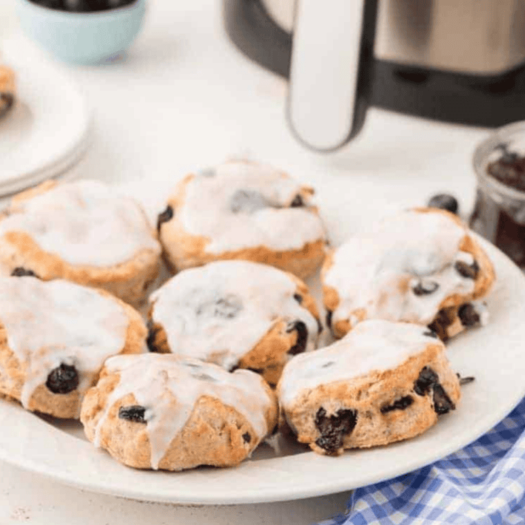 golden baked panera blueberry scones on parchment lined baking sheet fresh from oven