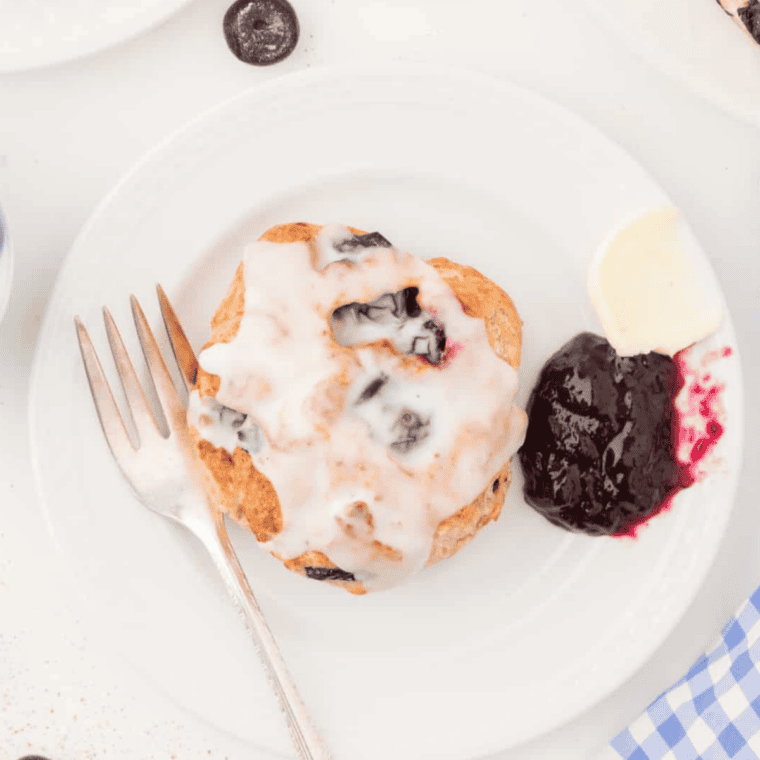 copycat panera blueberry scones with vanilla icing drizzle on cooling rack