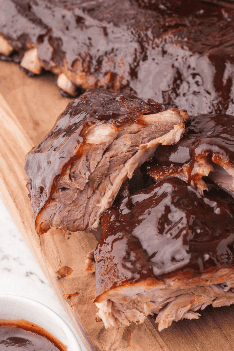 Copycat Sweet Baby Ray's BBQ sauce brushed onto a rack of ribs.