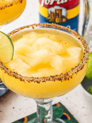 Copycat Texas Roadhouse Legendary Margarita in a black salt-rimmed glass with a lime wedge