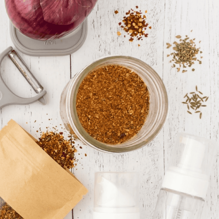 Homemade taco seasoning blend in a small white bowl with chili powder, cumin, and paprika