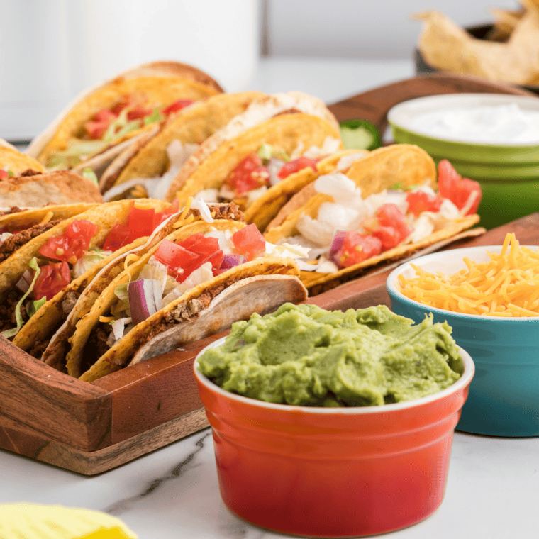 Close-up of a copycat Del Taco beef taco loaded with melted cheddar and crisp lettuce