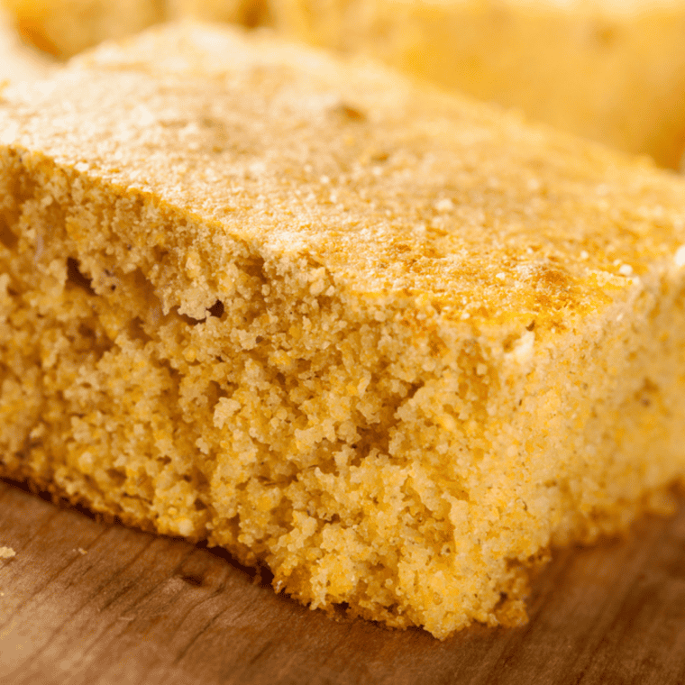 Sliced sweet cornbread squares served warm with butter and honey