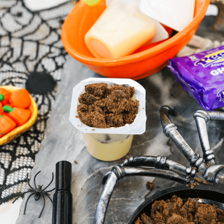 Halloween pudding cups decorated with candy pumpkins and marshmallow ghost Peeps