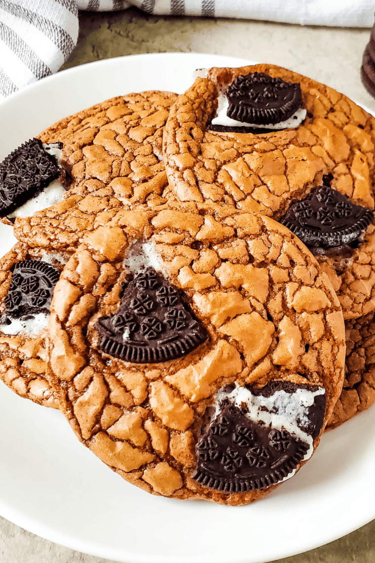 Easy Oreo brownie cookies served on a white plate with crinkly tops and Oreo chunks