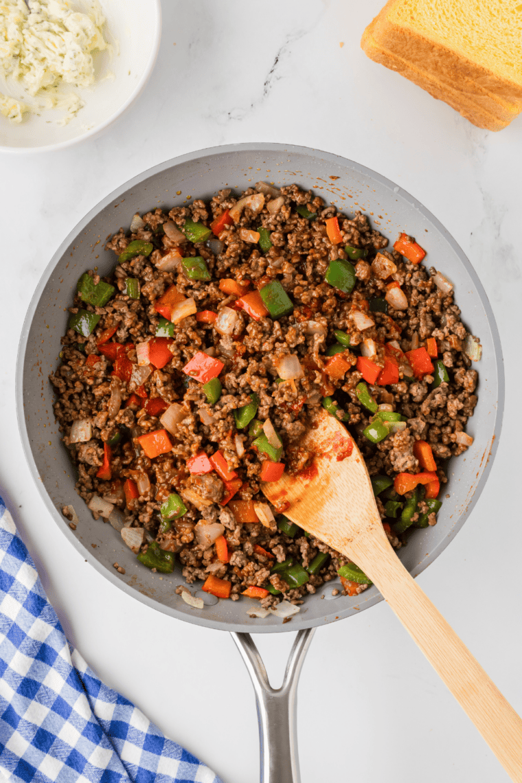 Ground beef browning and breaking apart in a skillet