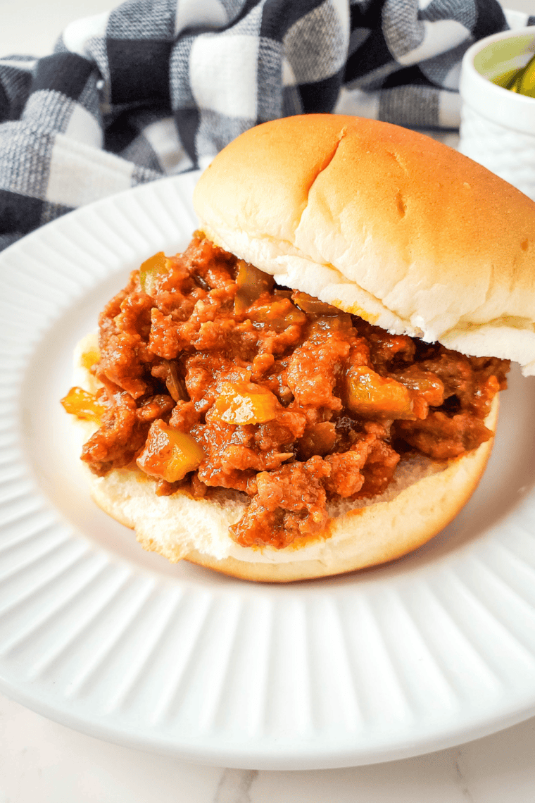 Two sloppy joe sandwiches on toasted buns served on a plate