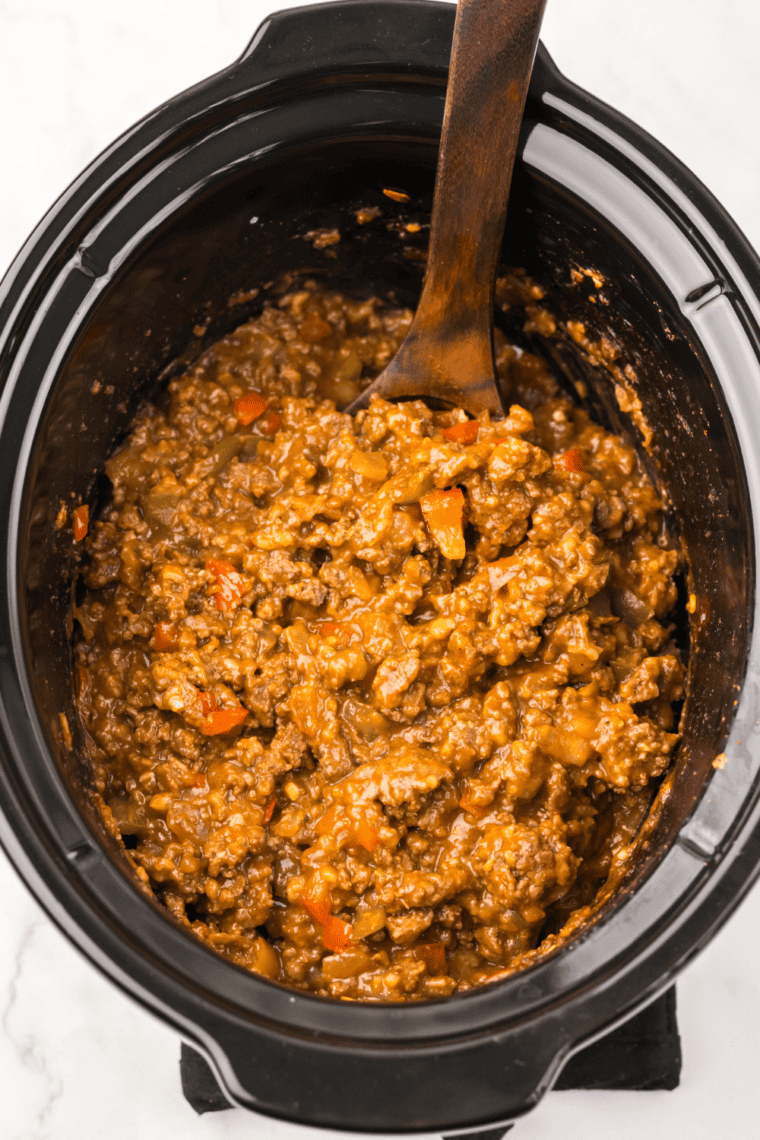Close-up of saucy sloppy joe meat piled on a soft hamburger bun