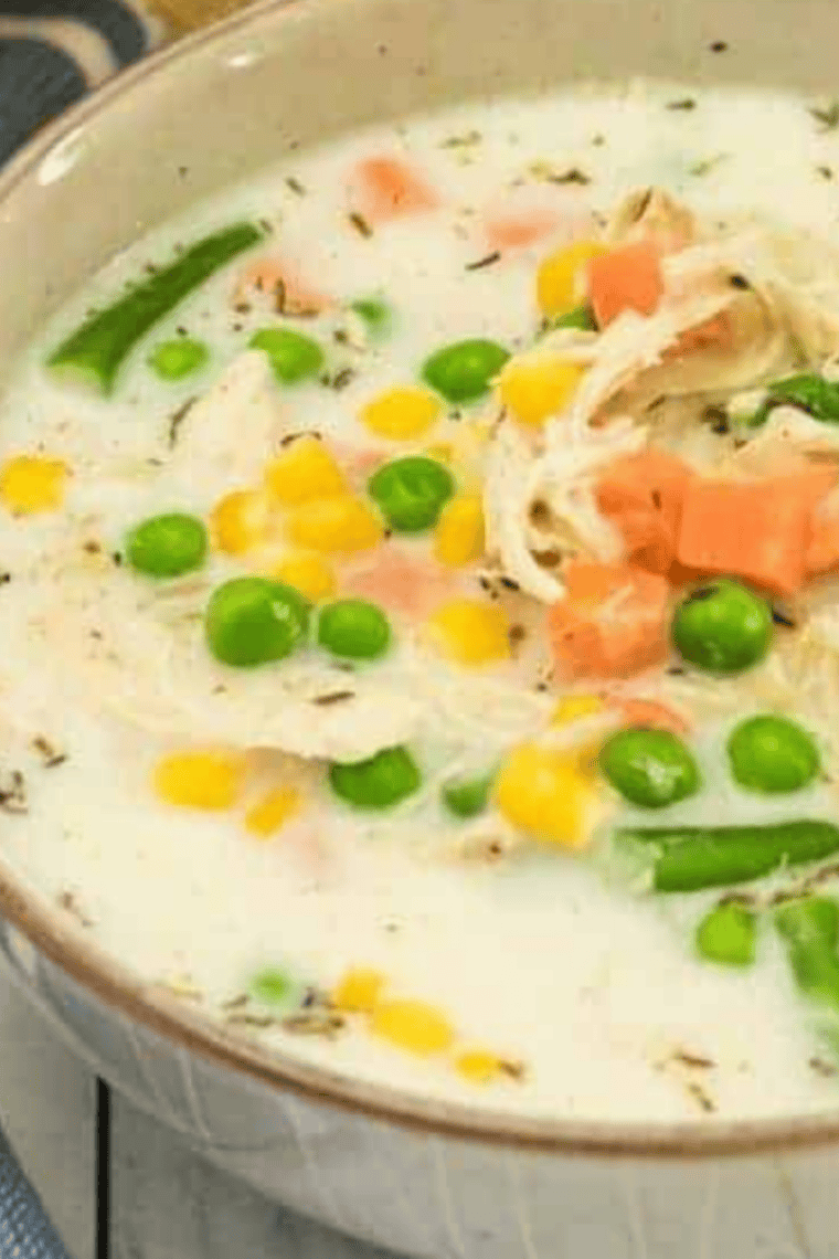 Shredded chicken topped with white chicken chili seasoning before stirring