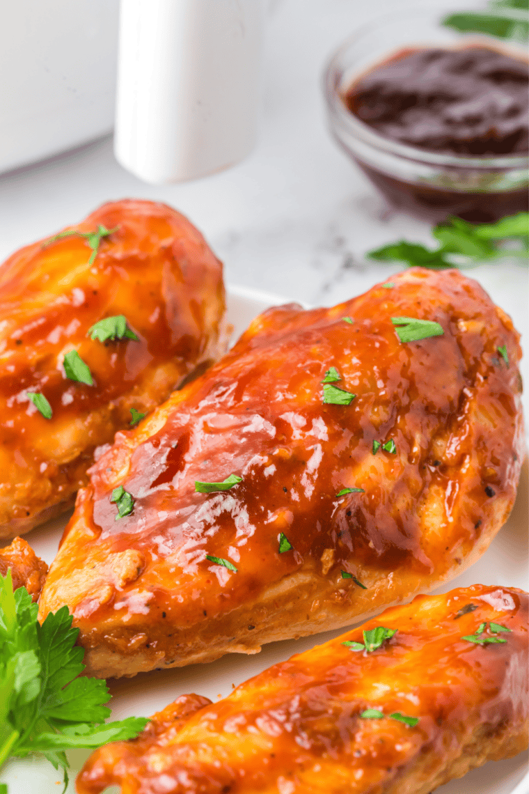 Close-up of grilled Jack Daniel's chicken brushed with glossy, caramelized whiskey glaze
