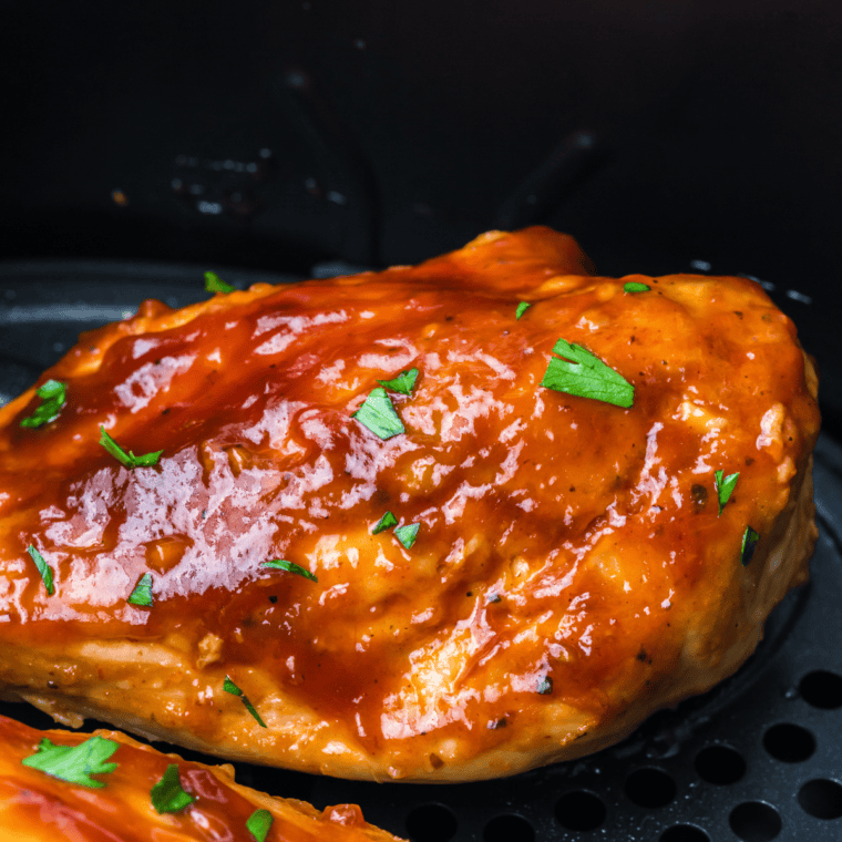 Close-up of grilled Jack Daniel's chicken brushed with glossy, caramelized whiskey glaze