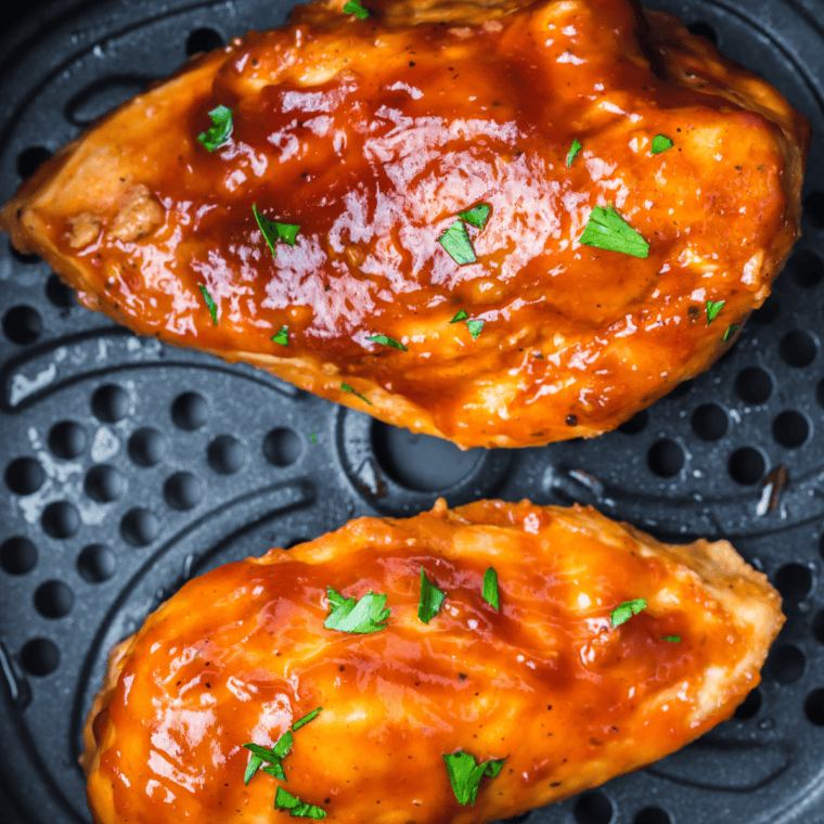 Jack Daniel's chicken breast glazed in sticky whiskey sauce, served over white rice with green onions