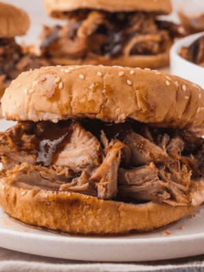 Jack Daniel's crock pot pulled pork piled on a toasted brioche bun with coleslaw and pickles