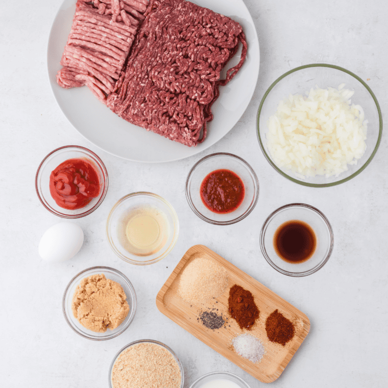 Ingredients for Jack Daniels meatloaf including ground beef, breadcrumbs, egg, onion, BBQ sauce, and Jack Daniels whiskey
