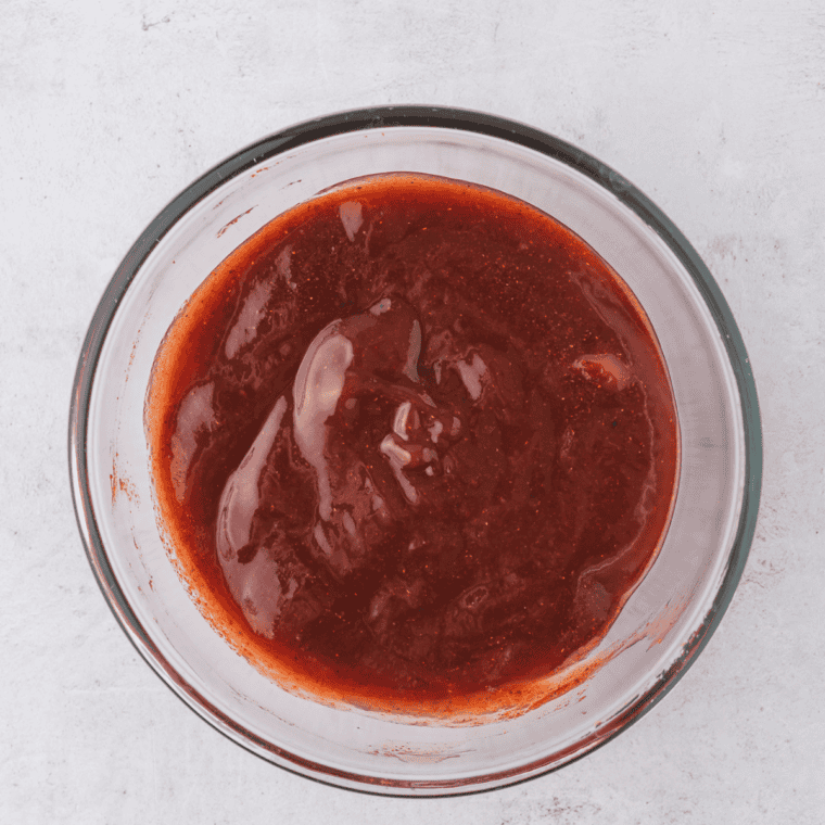 Whisking BBQ sauce, brown sugar, and Jack Daniels whiskey into a glossy meatloaf glaze