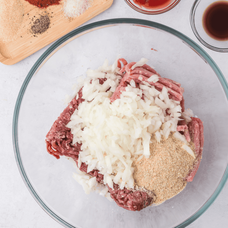 Ground beef, egg, onion, and seasonings mixed together for Jack Daniels meatloaf