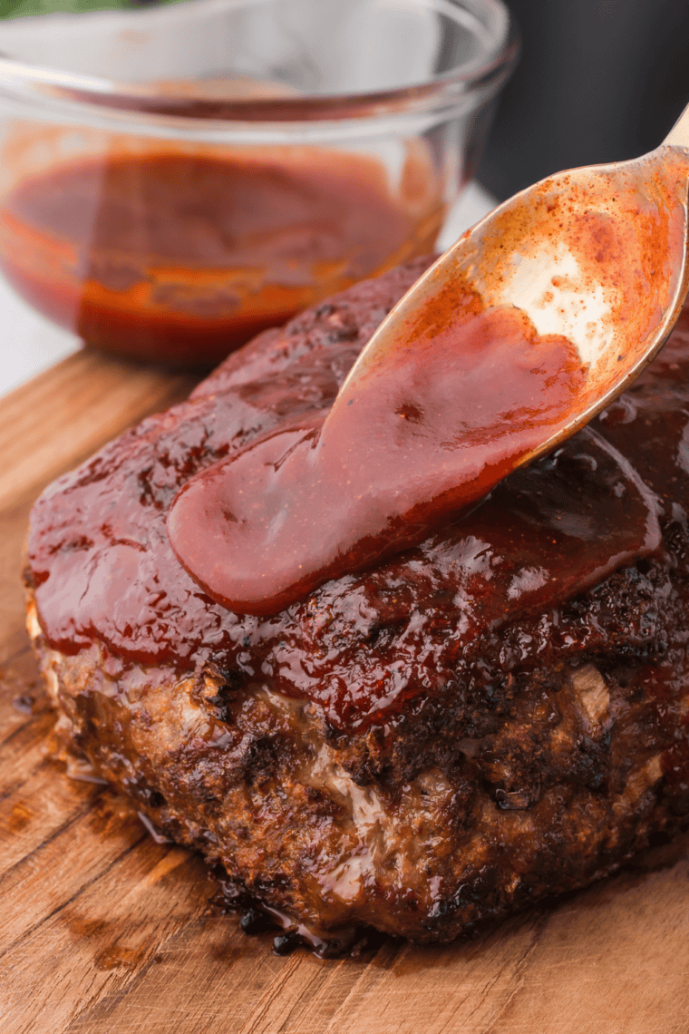 Whole Jack Daniels meatloaf on a sheet pan with a caramelized whiskey BBQ glaze