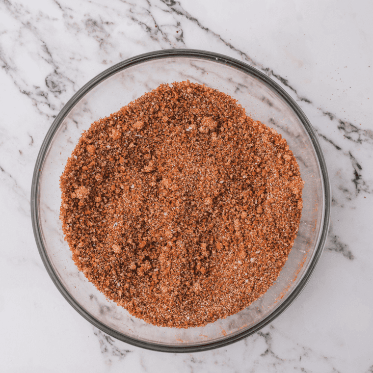 Brown gravy mix ingredients measured into a white bowl