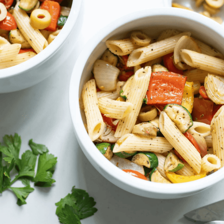 sprinkling mccormick salad supreme seasoning over finished pasta salad before serving
