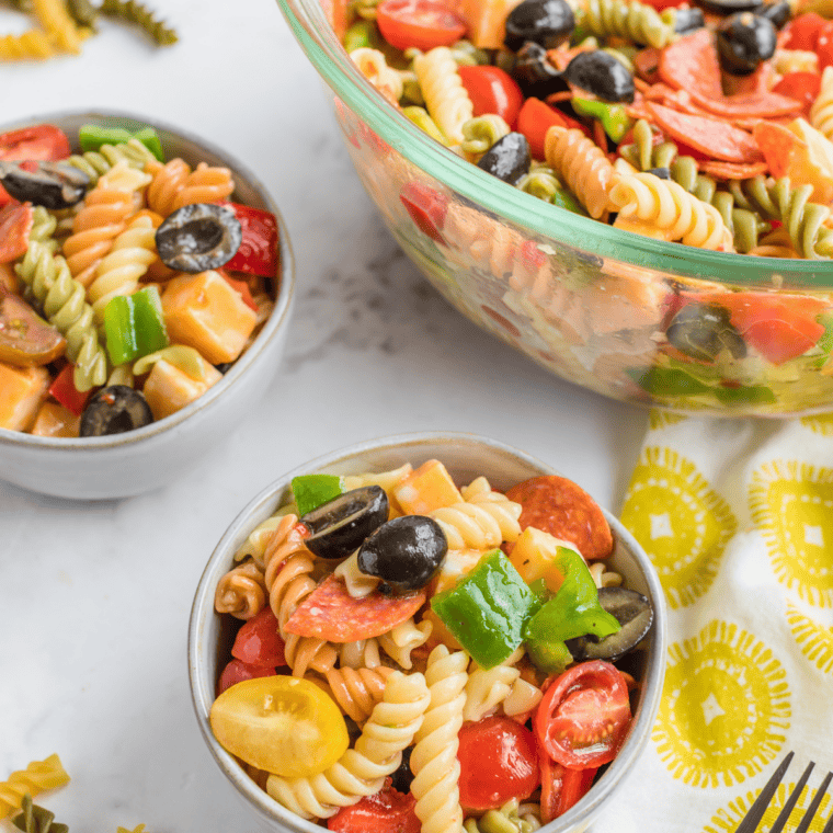 mccormick salad supreme recipe pasta salad in serving bowl with cucumbers and cherry tomatoes