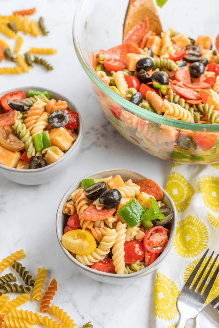 mccormick salad supreme recipe ready to serve at summer potluck with seasoning bottle beside bowl