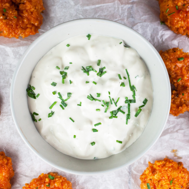 Homemade McDonald's copycat habanero ranch sauce served in a white dipping bowl on a wooden table.