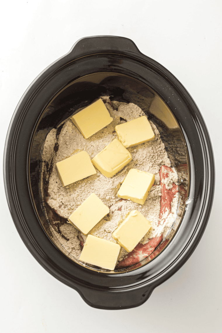 Season generously:
Pork shoulder topped with ranch and au jus seasoning packets in a slow cooker