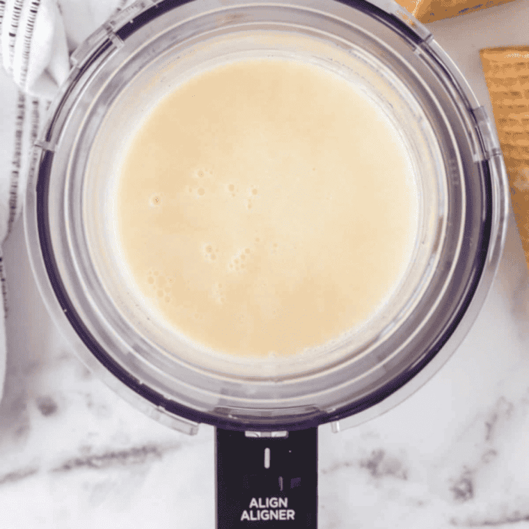 Whisking in whole milk, heavy cream, and vanilla extract until combined