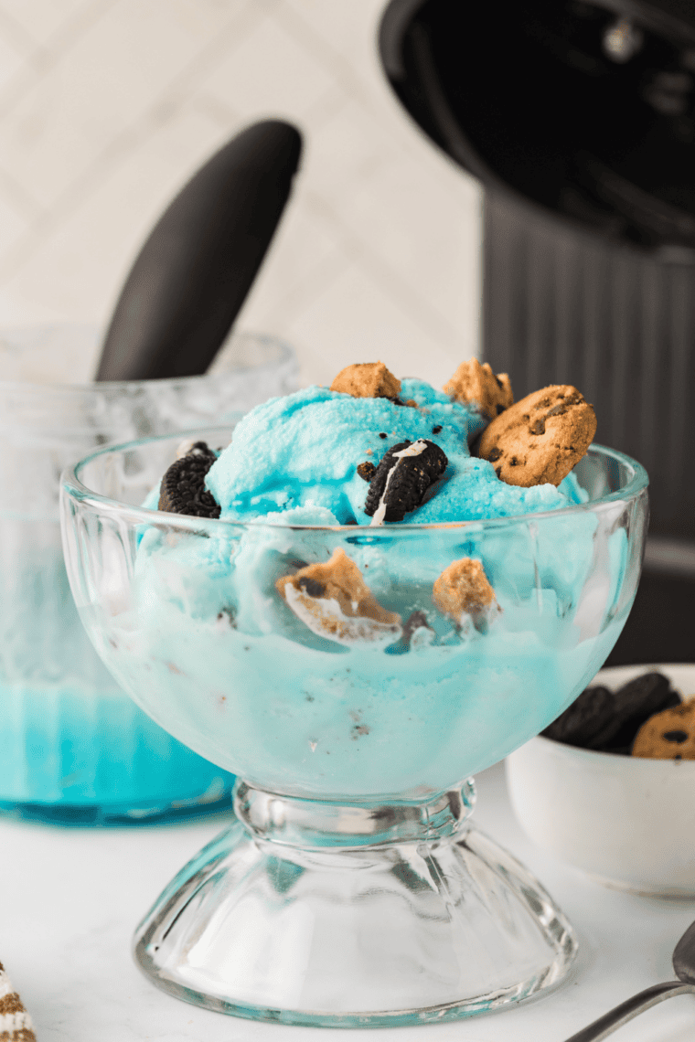 Ninja Creami cotton candy ice cream in a waffle cone with a pink and blue swirl