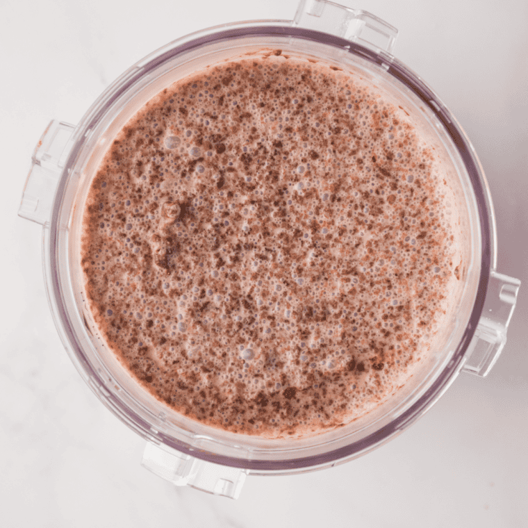 Filling a Ninja Creami pint with copycat Blue Bell Rocky Road base before freezing