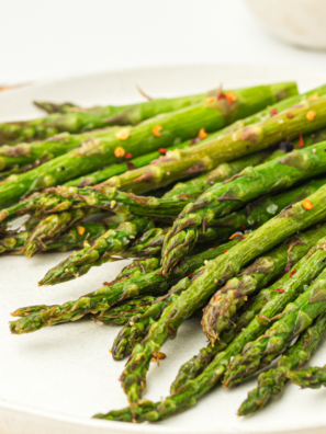 Ninja Crispi asparagus spears cooked crispy and golden in an air fryer basket