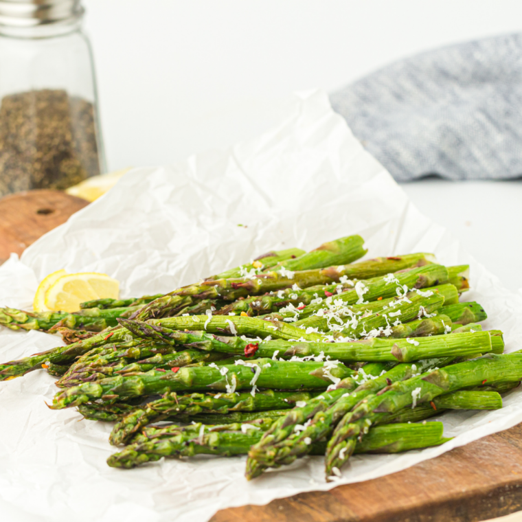 Crispy Ninja Crispi asparagus with melted Parmesan and lemon, served on a plate