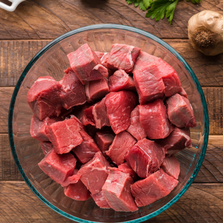 Raw sirloin steak cut into even 1-inch cubes and patted dry on a wooden board
