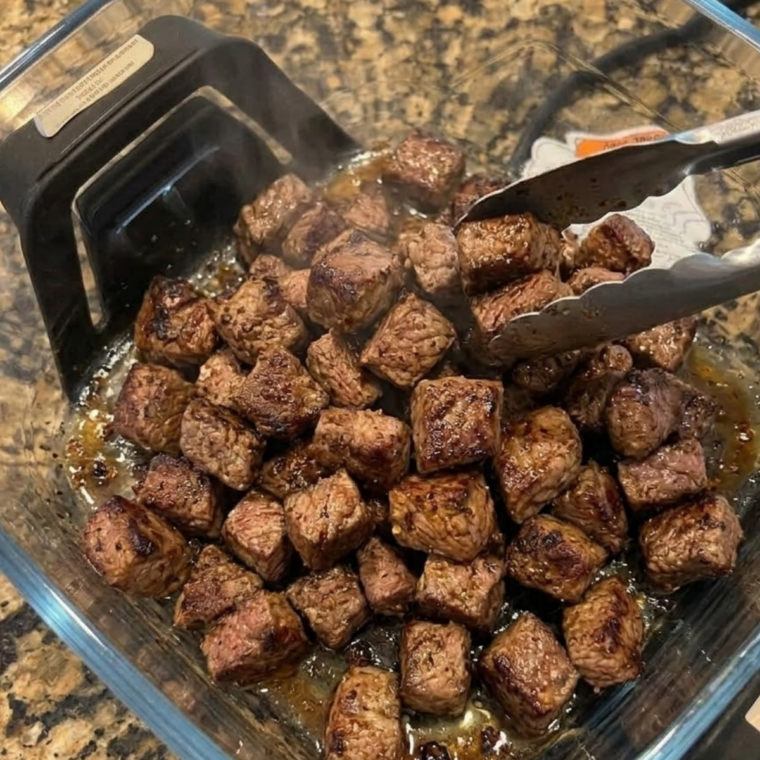Golden garlic butter steak bites tossed and garnished with fresh parsley