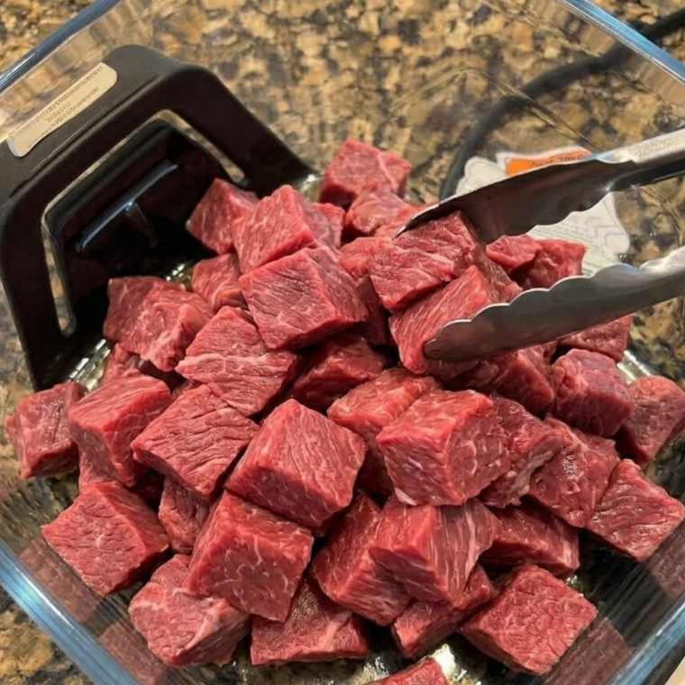 Ninja Crispi air fryer running Max Crisp with steak bites searing inside.