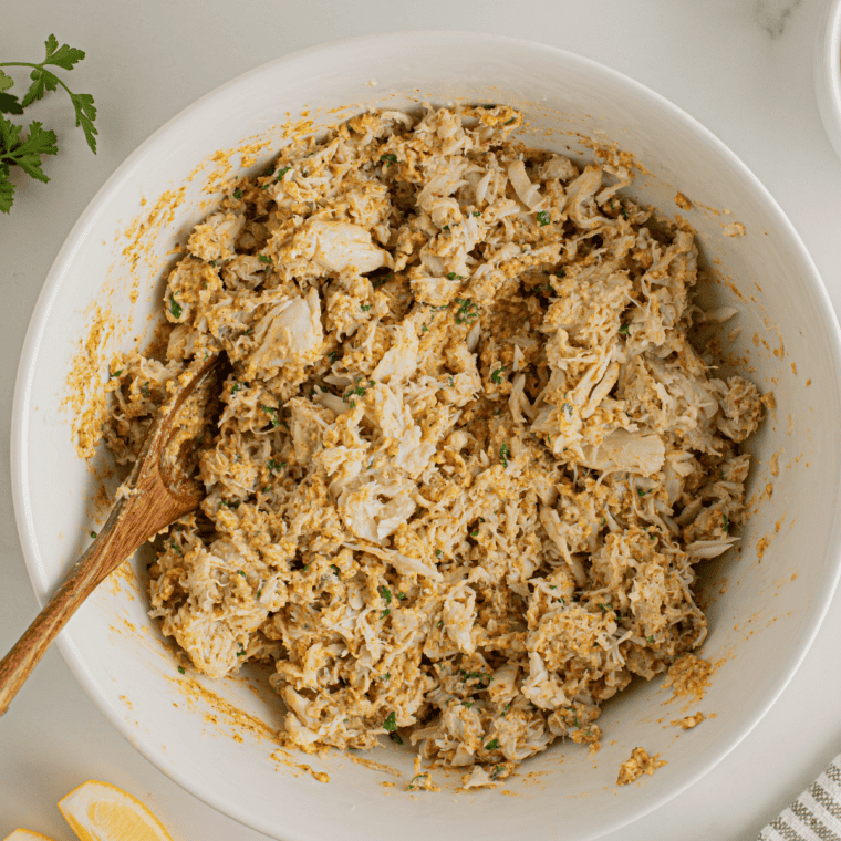 Whisking egg, mayonnaise, Dijon, and Old Bay into a creamy crab cake binder.