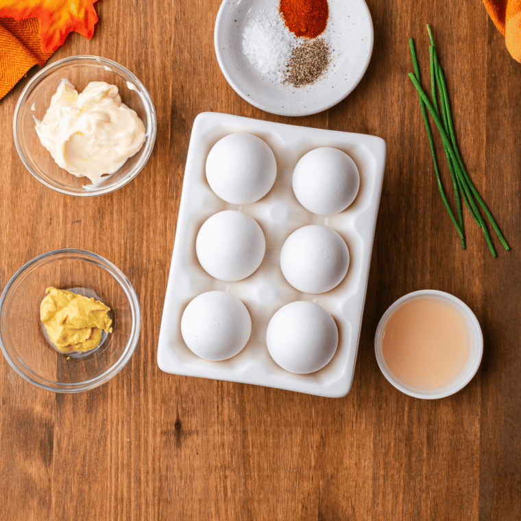 Ingredients for smoked deviled eggs including eggs, mayonnaise, mustard, and smoked paprika