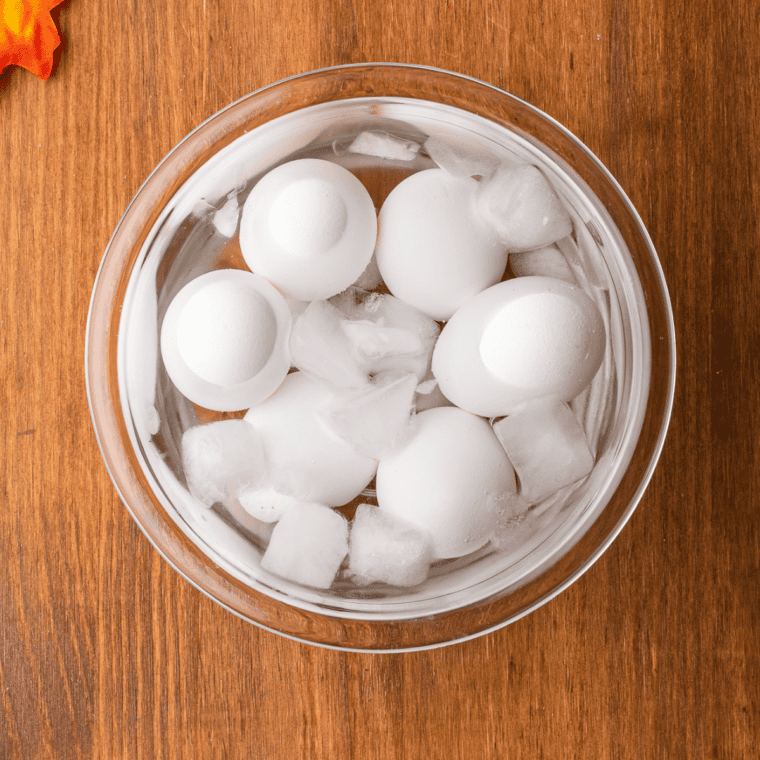 Cooked eggs soaking in ice water.