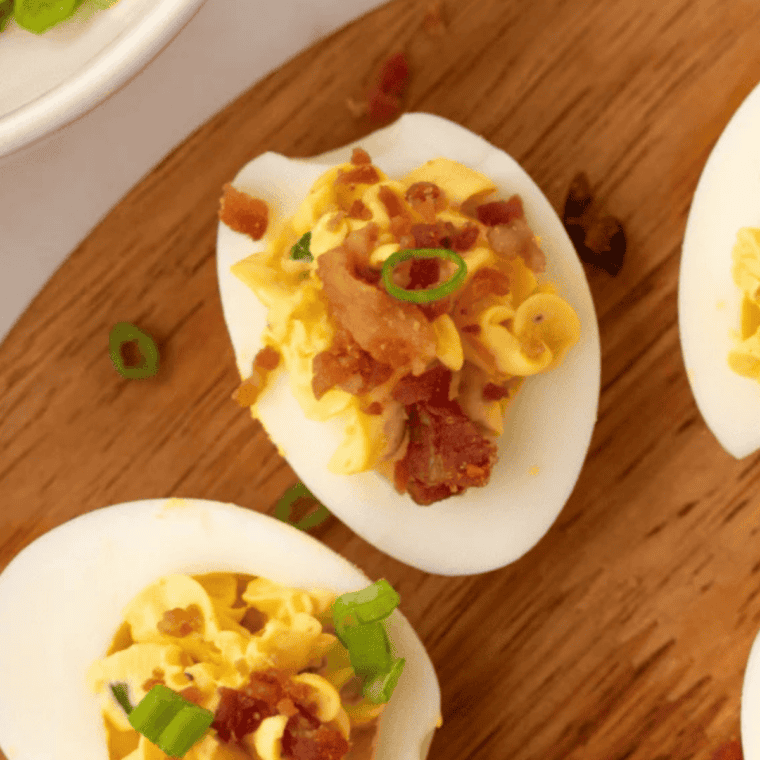 Finished deviled eggs dusted with smoked paprika and fresh chives